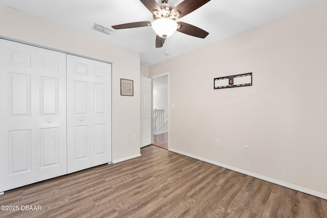 5 Cantilever Ct, Ormond Beach, FL 32174 - unfurnished bedroom with wood finished floors, a closet, baseboards, and a ceiling fan