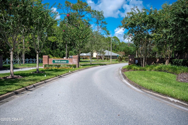 5 Cantilever Ct, Ormond Beach, FL 32174 - view of asphalt street featuring curbs, street lights, and view of wooded area