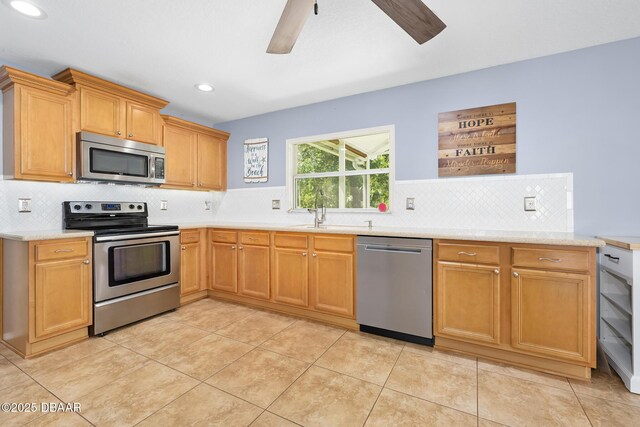 5 Cantilever Ct, Ormond Beach, FL 32174 - kitchen featuring stainless steel appliances, a sink, a ceiling fan, light countertops, and backsplash