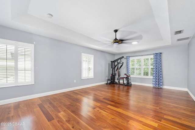 5 Cantilever Ct, Ormond Beach, FL 32174 - unfurnished room with a tray ceiling, a ceiling fan, wood finished floors, and baseboards