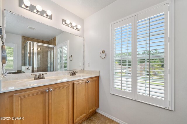 5 Cantilever Ct, Ormond Beach, FL 32174 - bathroom featuring a stall shower, double vanity, tile patterned flooring, and baseboards