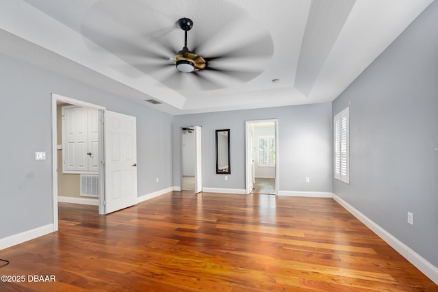 5 Cantilever Ct, Ormond Beach, FL 32174 - unfurnished bedroom with a raised ceiling, wood finished floors, and baseboards