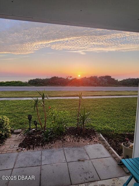 patio terrace at dusk with a lawn