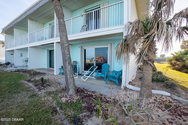 back of property with a patio and a balcony