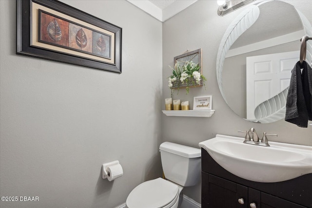 bathroom with vanity, baseboards, and toilet