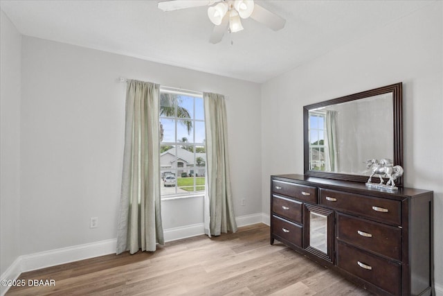 interior space featuring baseboards, light wood-style flooring, and ceiling fan