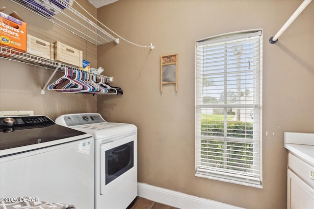 clothes washing area with separate washer and dryer, baseboards, laundry area, and wood finished floors