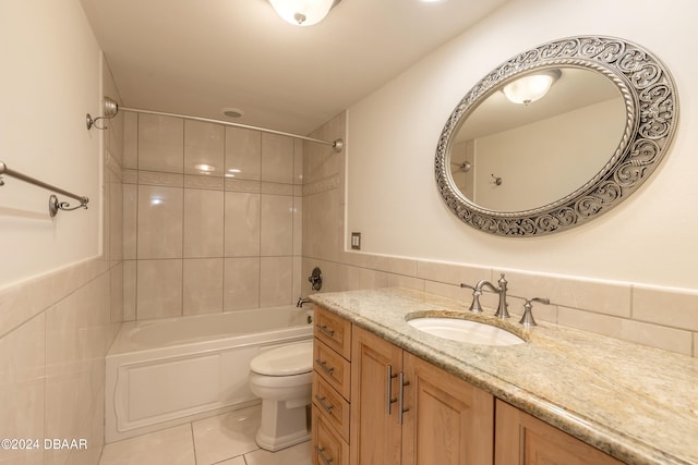 full bathroom featuring tile patterned floors, toilet, and tile walls