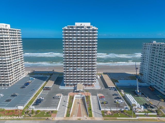 drone / aerial view with a water view and a beach view