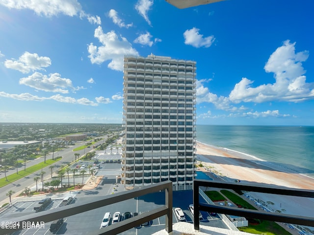 balcony featuring a beach view and a water view