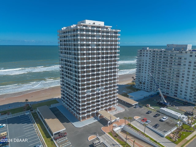 birds eye view of property featuring a water view and a beach view