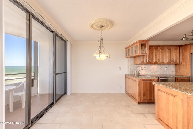 kitchen with light stone counters, stainless steel dishwasher, pendant lighting, decorative backsplash, and a water view