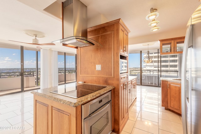 kitchen featuring island exhaust hood, stainless steel appliances, a kitchen island, and plenty of natural light