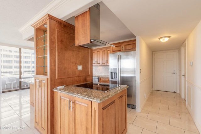 kitchen with stone counters, wall chimney range hood, tasteful backsplash, stainless steel fridge with ice dispenser, and black electric stovetop