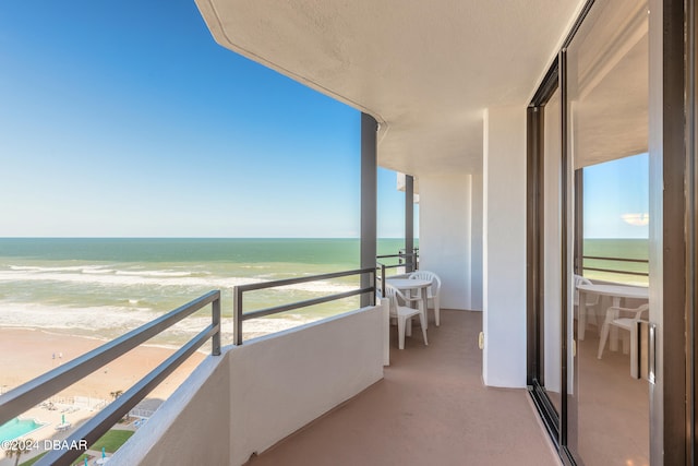 balcony with a beach view and a water view