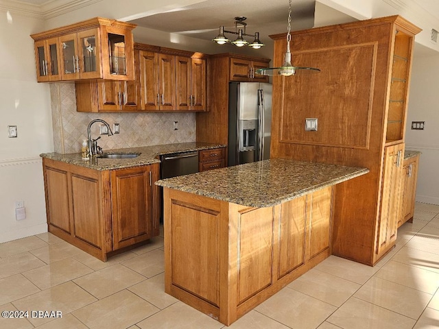 kitchen featuring kitchen peninsula, appliances with stainless steel finishes, decorative backsplash, and dark stone counters