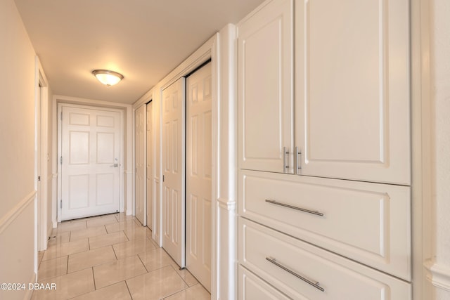 corridor featuring light tile patterned floors