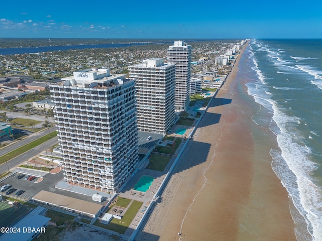 bird's eye view featuring a water view and a beach view