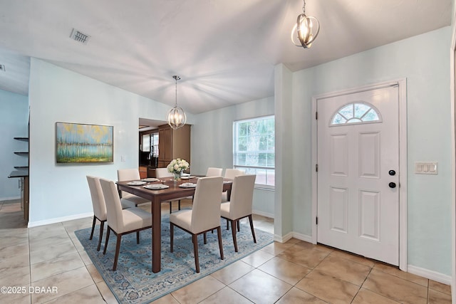 952 Northbrook Dr, Ormond Beach, FL 32174 - dining room featuring baseboards, light tile patterned floors, and a chandelier