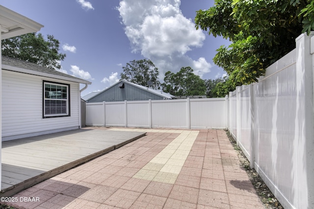 952 Northbrook Dr, Ormond Beach, FL 32174 - fenced backyard featuring a wooden deck and a patio area