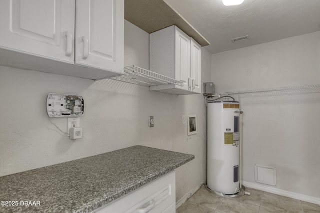 952 Northbrook Dr, Ormond Beach, FL 32174 - laundry area with water heater, cabinet space, hookup for a washing machine, light tile patterned flooring, and electric dryer hookup