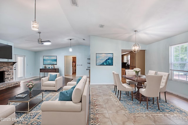 952 Northbrook Dr, Ormond Beach, FL 32174 - living area featuring vaulted ceiling, baseboards, a brick fireplace, and a ceiling fan