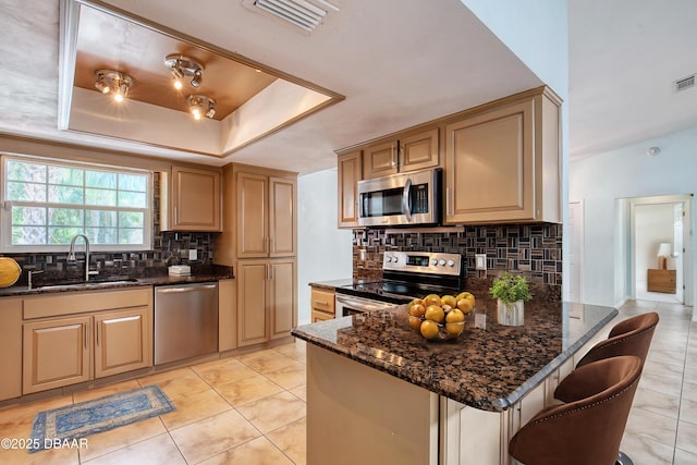 952 Northbrook Dr, Ormond Beach, FL 32174 - kitchen with appliances with stainless steel finishes, a sink, backsplash, dark stone counters, and a peninsula