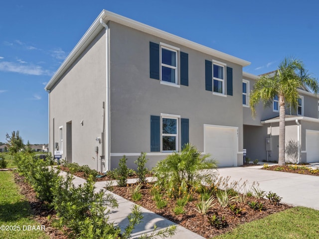 2716 Golden Trout Ln, Edgewater, FL 32141 - view of front facade with an attached garage, stucco siding, and concrete driveway