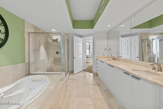 231 Riverside Dr Unit 1904, Holly Hill, FL 32117 - ensuite bathroom with a shower stall, a jetted tub, double vanity, recessed lighting, and baseboards