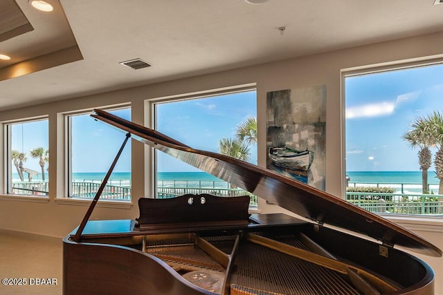 miscellaneous room with a wealth of natural light and a water view