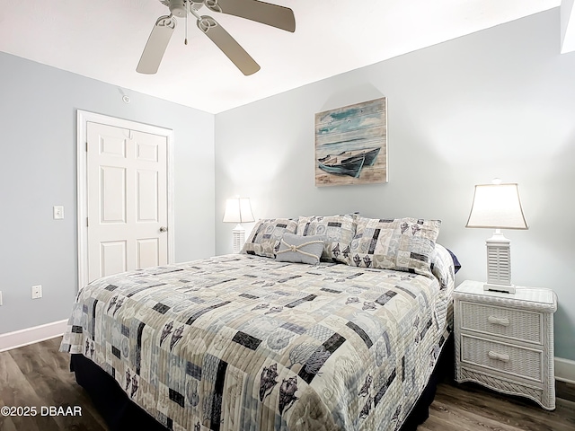 bedroom with dark hardwood / wood-style floors and ceiling fan