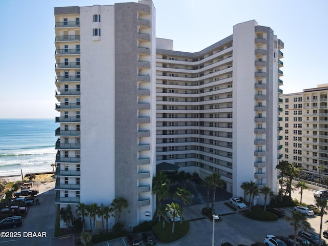 view of property featuring a view of the beach and a water view