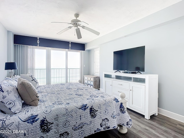 bedroom with access to exterior, dark wood-type flooring, and ceiling fan