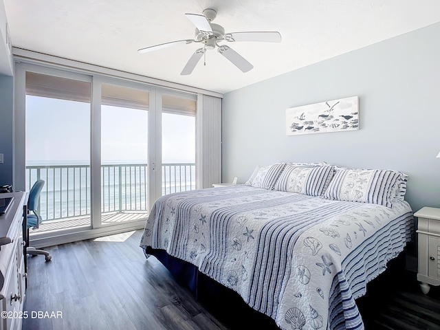 bedroom with a water view, ceiling fan, dark hardwood / wood-style flooring, and access to outside