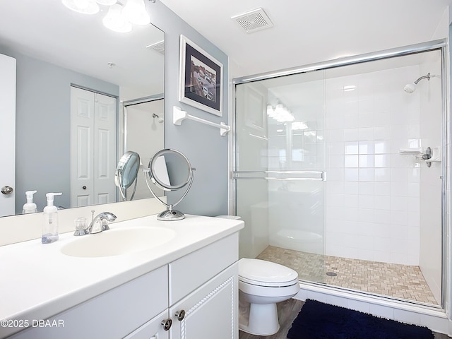 bathroom with vanity, toilet, and walk in shower