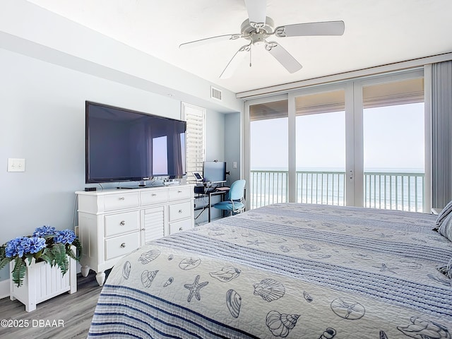 bedroom with access to exterior, hardwood / wood-style flooring, and ceiling fan