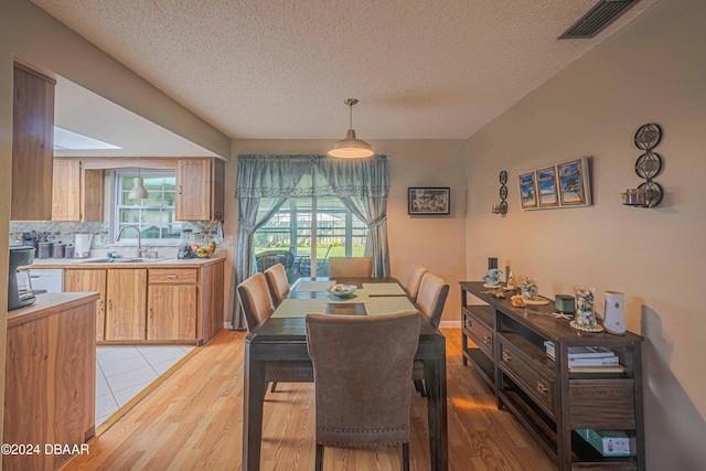 25 Laughing Gull Ln, Edgewater, FL 32141 - dining room featuring light wood finished floors and a textured ceiling