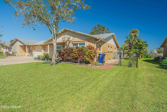 25 Laughing Gull Ln, Edgewater, FL 32141 - ranch-style house featuring driveway, a gate, brick siding, and an attached garage