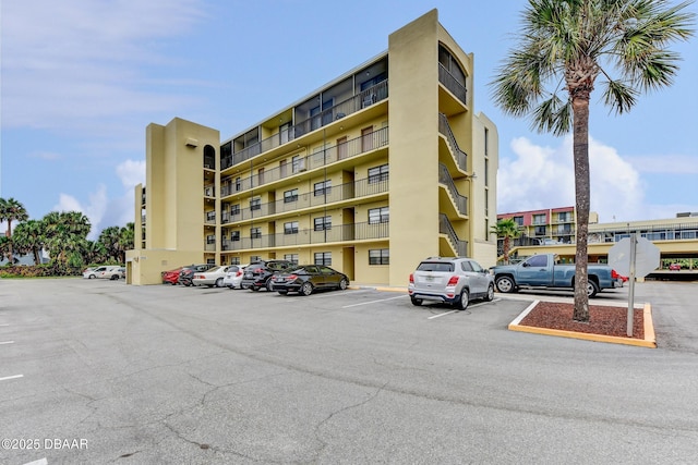 view of building exterior featuring uncovered parking