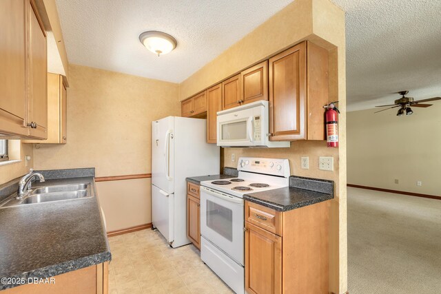 840 Center Ave Unit 280, Holly Hill, FL 32117 - kitchen featuring white appliances, a textured ceiling, a ceiling fan, dark countertops, and brown cabinets