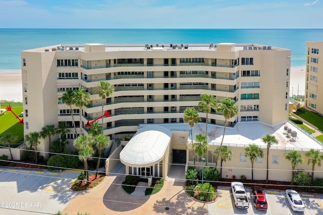 view of property featuring uncovered parking and a water view