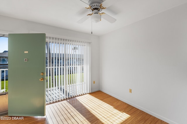 unfurnished room with hardwood / wood-style floors, plenty of natural light, and ceiling fan