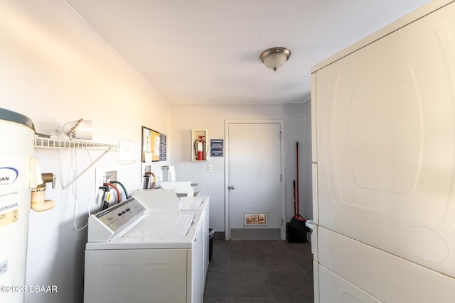 laundry area featuring dark tile patterned floors and independent washer and dryer