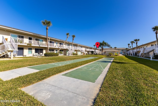 view of home's community featuring a lawn