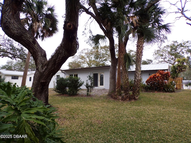 view of property exterior with a lawn