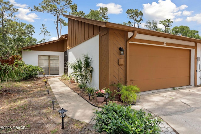 42 Soco Trl, Ormond Beach, FL 32174 - mid-century home featuring board and batten siding and a garage