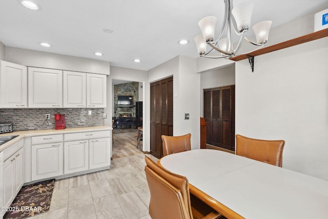 42 Soco Trl, Ormond Beach, FL 32174 - dining room with a chandelier, recessed lighting, and a wood stove