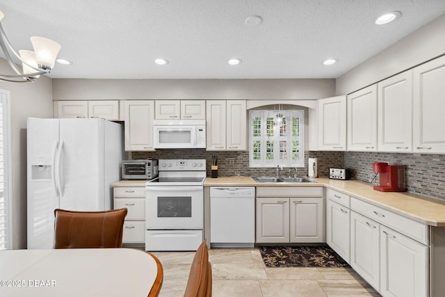 42 Soco Trl, Ormond Beach, FL 32174 - kitchen featuring white appliances, a sink, tasteful backsplash, light countertops, and recessed lighting