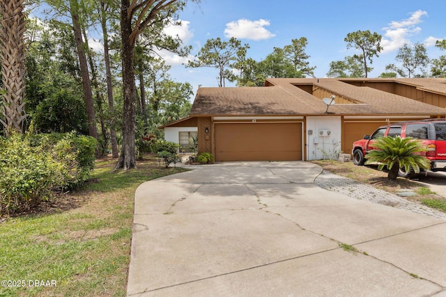 42 Soco Trl, Ormond Beach, FL 32174 - view of front of house featuring a garage, driveway, and a shingled roof