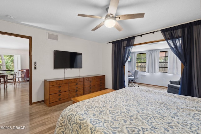 42 Soco Trl, Ormond Beach, FL 32174 - bedroom featuring multiple windows, wood finished floors, and a ceiling fan